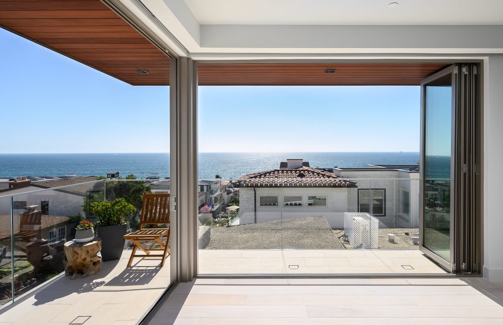 Ocean view from luxury home with hardwood flooring and glass windows